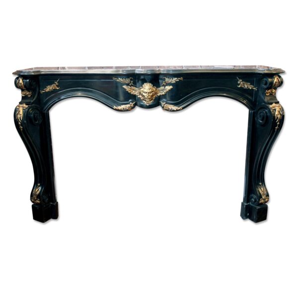 Ornate black marble mantel with bronze detail, shown front view with a carved frieze and decorative bronze mounts.