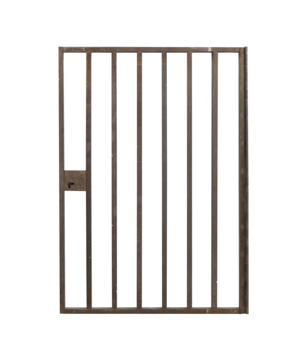 1960s brass bank teller door with vertical bars and a small lock panel on the left side.