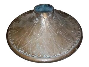 Antique bronze base with ornate leaf-like detailing and a wide circular form, shown from above.