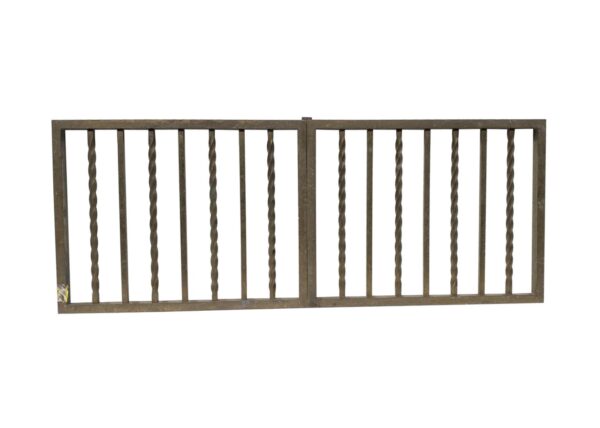 Pair of reclaimed brass bank teller gates with alternating twisted and straight spindles, shown side by side.