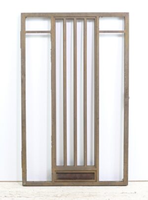 1940s Art Deco bronze bank teller door with a tall framed center section and a small lower panel reading “Next Window.”