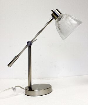 Brushed nickel desk lamp with an adjustable arm, clear prism glass shade, and oval base shown in side view.