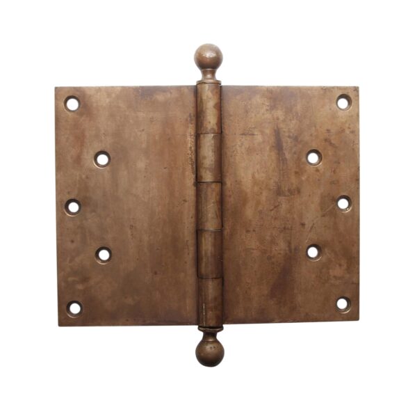 Antique brass butt door hinge with ball tips, shown closed with five knuckles and staggered screw holes on both leaves.