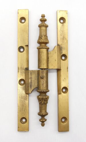 Pair of antique bronze door hinges with ornate steeple tips, shown closed with a template hole pattern and two knuckles visible.