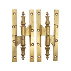 Pair of antique bronze paumelle door hinges with ornate steeple tips and multiple mounting holes, shown as a matched pair in working condition.