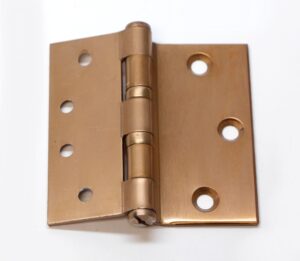 Vintage bent door hinge with five knuckles and round screw holes, shown closed in an antique brass finish.