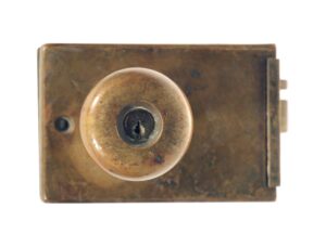 Antique bronze unit lock with a round knob and rectangular lock box, shown in close-up from the front.