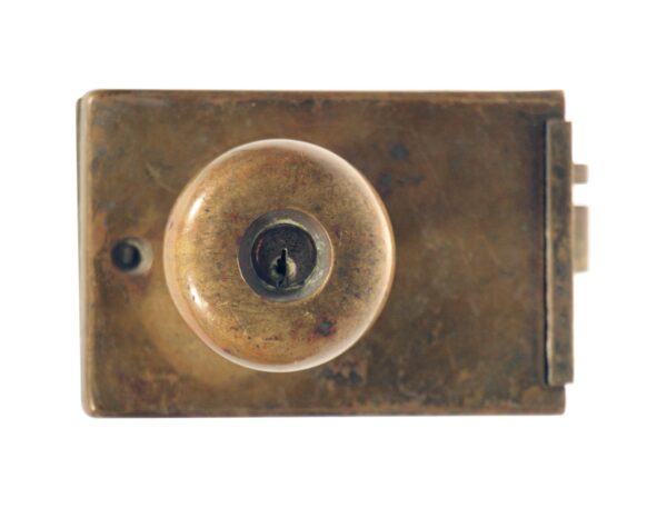 Antique bronze unit lock with a round knob and rectangular lock box, shown in close-up from the front.