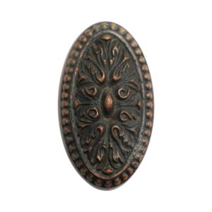 Oval antique bronze door knob with an ornate Louis XVI floral relief and beaded border.