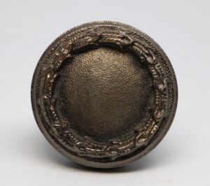 Concentric passage door knob with a nickel finish, shown in close-up from the front.