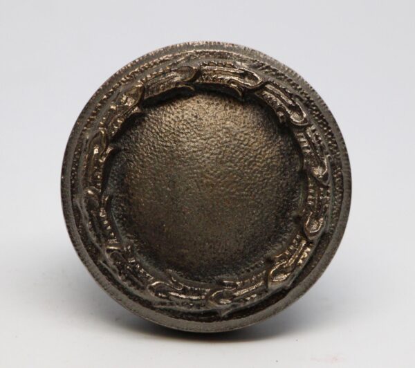 Concentric passage door knob with a nickel finish, shown in close-up from the front.