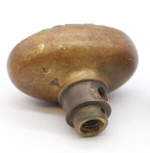 Antique bronze oval door knob with a threaded metal stem shown in close-up.