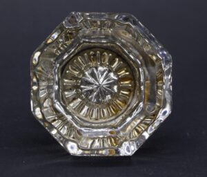 Clear octagon glass door knob with a star center, shown in close-up from the front.