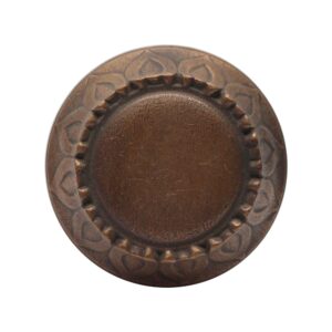 Vintage bronze entry door knob with a radial center and sunflower leaf trim.