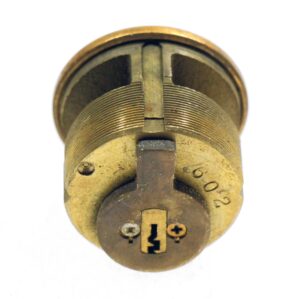 Bronze lock cylinder shown in close-up, with no key included and a numbered face visible on the front.