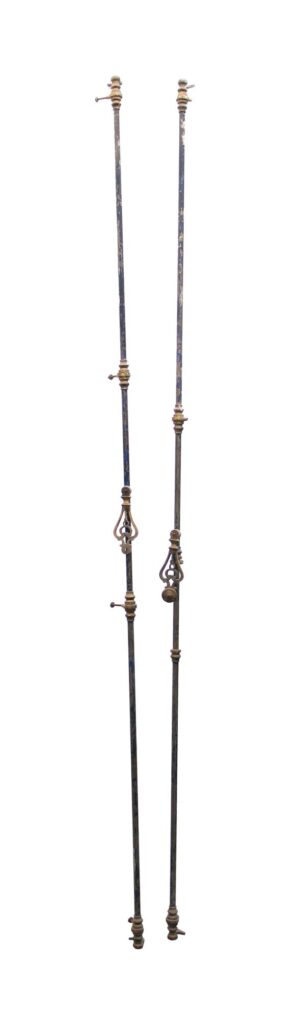 Pair of black brass cremone bolts shown side by side, each with decorative handle details and long vertical rods.