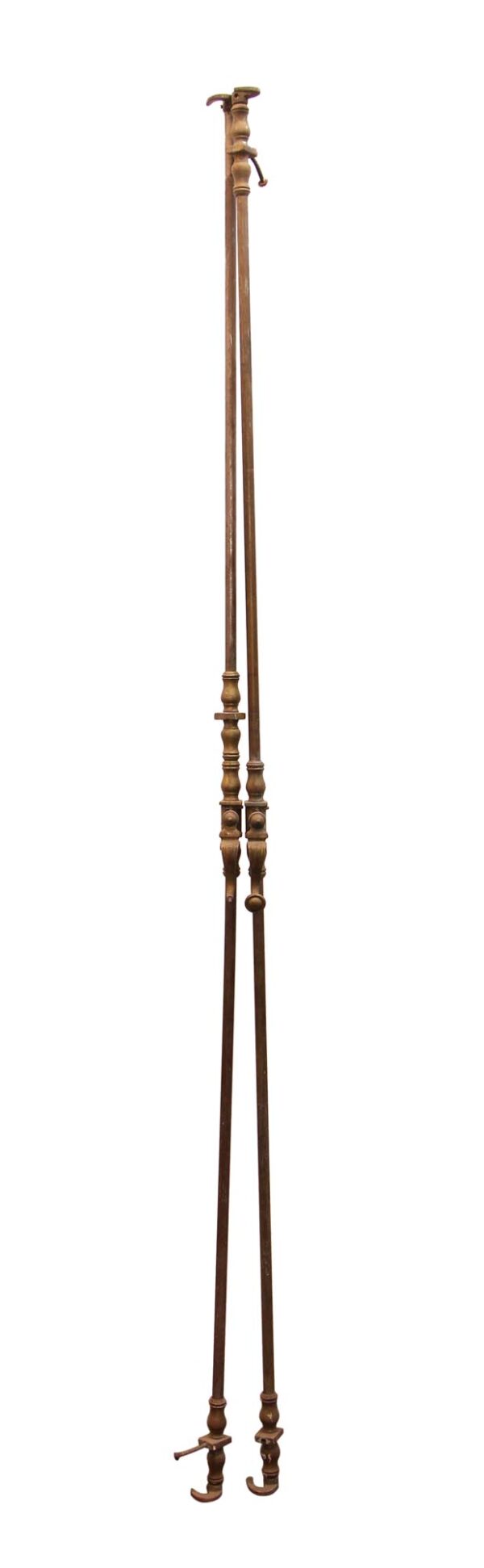 Pair of traditional brass cremone bolts shown in full length, with one bolt missing parts and visible decorative handles and hooked ends.