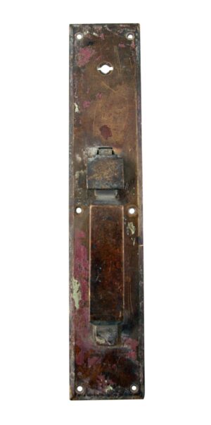Antique bronze commercial door pull with a thumb latch and lock feature, shown as a vertical metal handle plate with mounting holes and a raised center section.