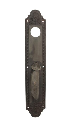 Antique bronze neoclassical door pull with leafy handle detail, a thumb latch, and a decorative lock insert opening.