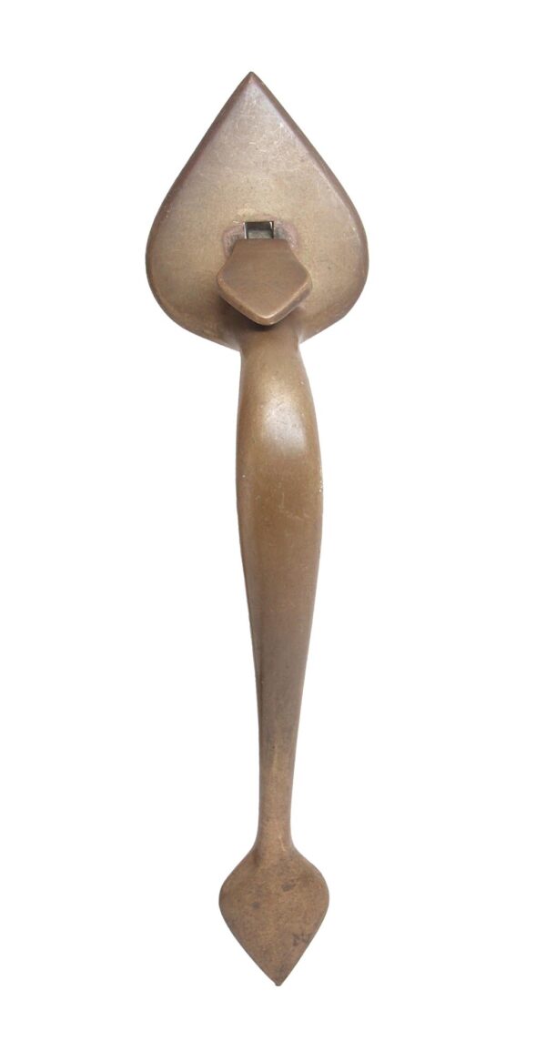 Colonial-style brass door handle with a spade-shaped back plate and thumb latch shown from the front.