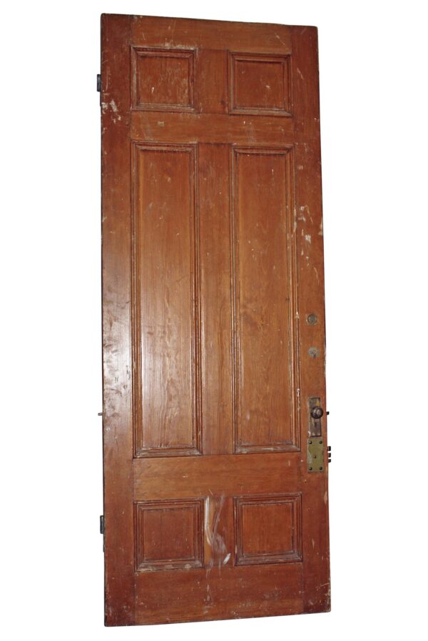 Antique wood entry door with six panels, shown front on and featuring worn surface details and visible hardware on the right side.