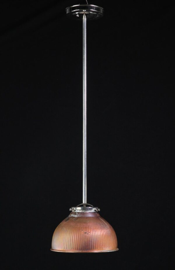 Industrial pendant light with a long pole and a ribbed domed shade, shown in copper plated finish with visible age wear and a polished nickel or steel mount.