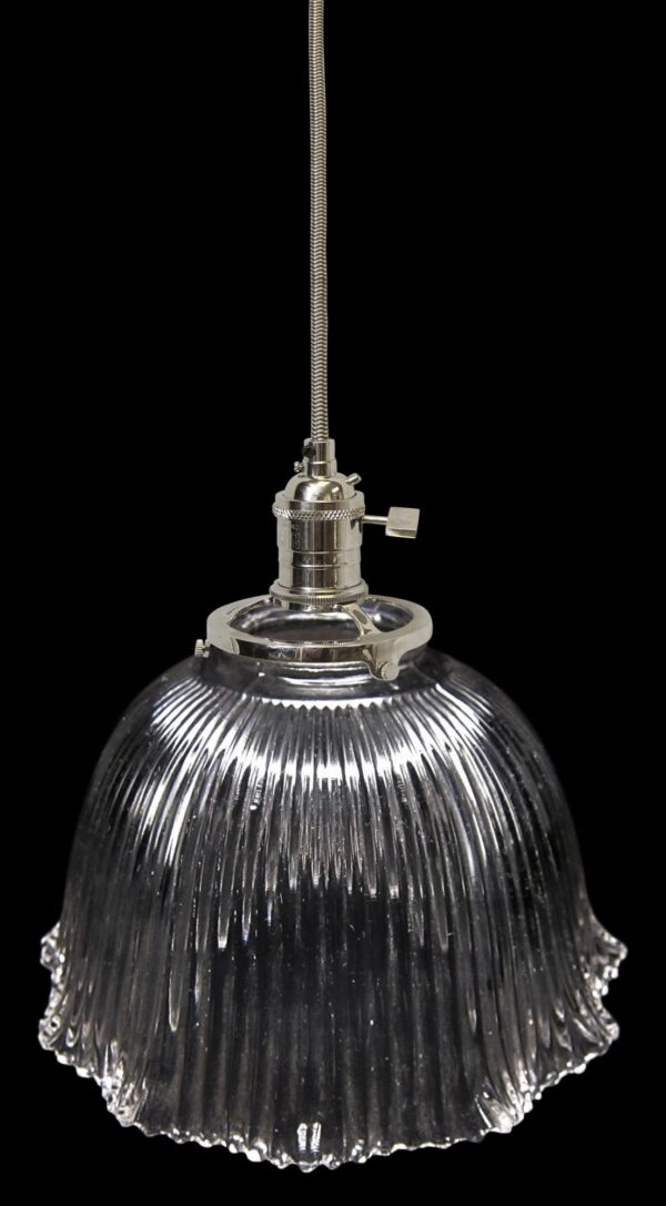 Clear glass pendant light with a ribbed Holophane globe and a long flexible cord.