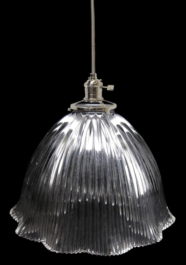 Clear Holophane glass pendant light with a ribbed dome shade and metal fitter.