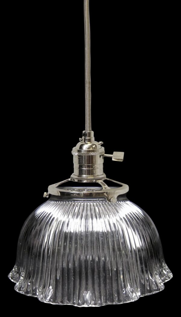 Clear glass pendant light with a ribbed globe and fitted suspension hardware, shown hanging vertically against a plain background.