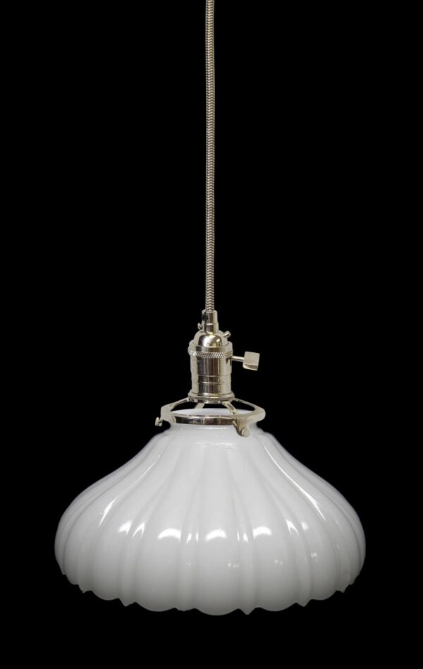White milk glass pendant light with a fluted shade and polished nickel fitter, shown with a long cord.