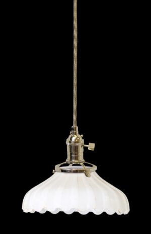 Pendant light with a white fluted milk glass shade and a polished nickel fitter, shown in a hanging view with a long cloth cord.