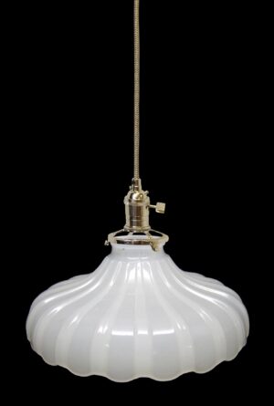 Pendant light with a white fluted milk glass shade and polished nickel fitter, shown hanging from a braided cord.