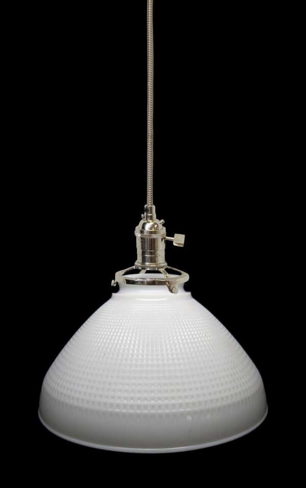 White milk glass pendant light with a cone-shaped shade and polished nickel fitter, shown with a cloth cord hanging from the top.