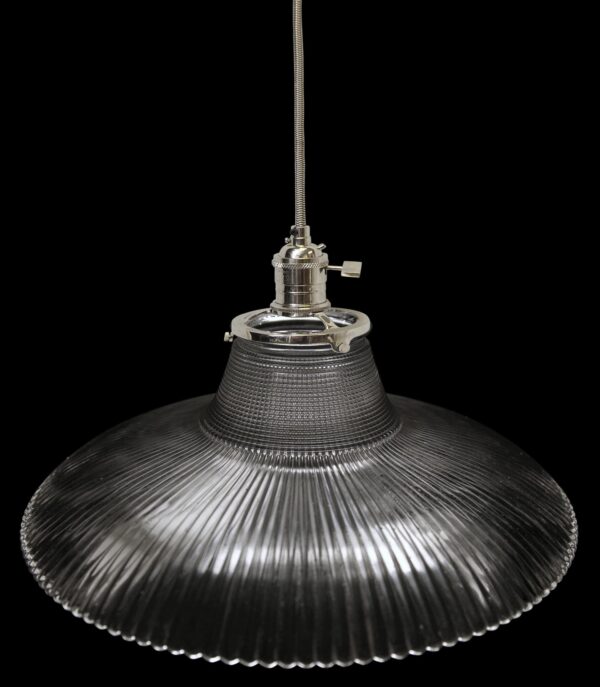 Clear prism glass pendant light with a fitted metal canopy and hanging cord, shown in a close-up view from below.