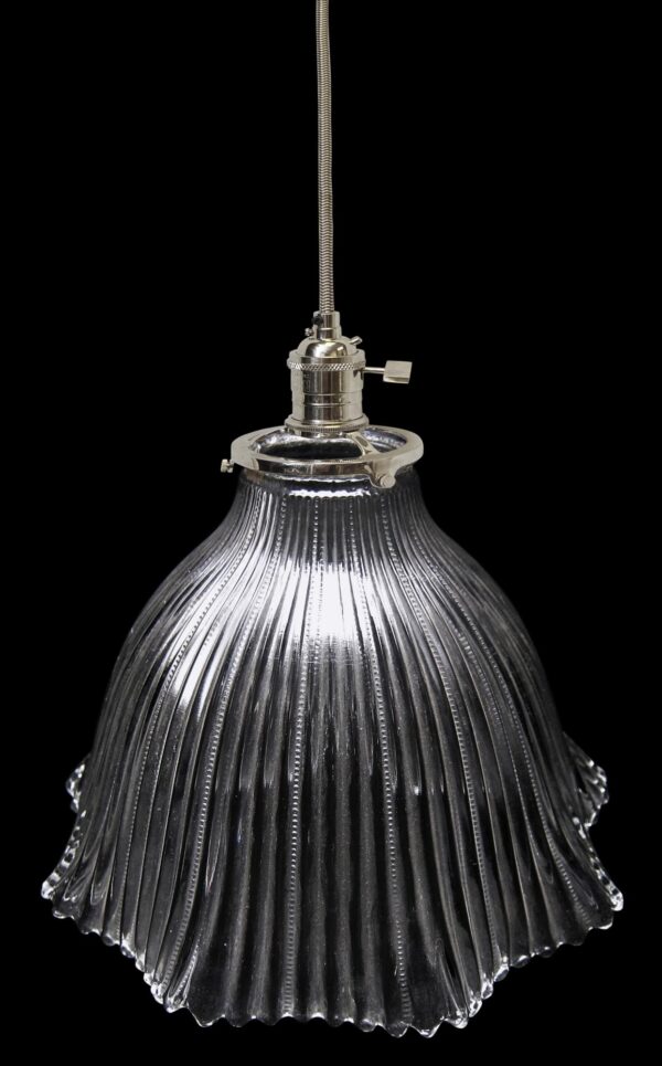 Clear glass pendant light with a ribbed Holophane-style globe and hanging fitter.