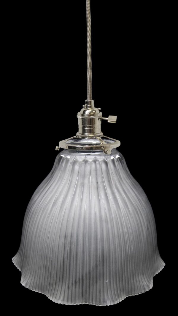 Frosted glass pendant light with a hanging fitter and ribbed globe shade.
