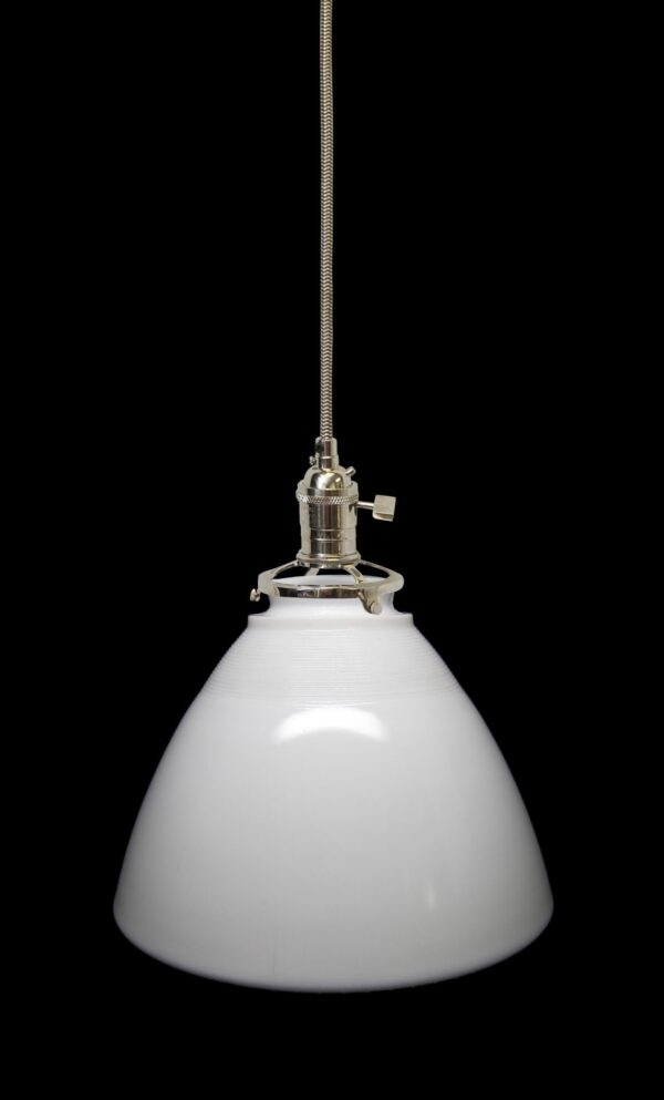 Cone pendant light with a white milk glass shade and polished nickel fitter, shown hanging from a cloth cord.