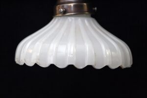 Fluted white milk glass pendant light shade with a polished metal fitter at the top.