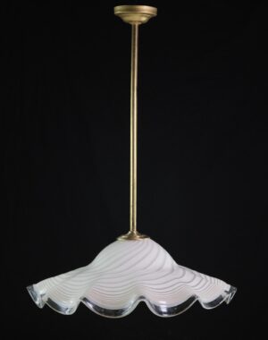 Glass pendant light with an antique brass rod and a rippled white shade with a clear scalloped brim.