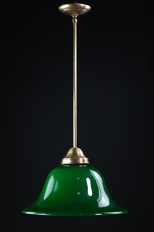 Pendant light with a green encased glass shade and antique brass pole.