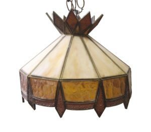 Tiffany-style stained glass pendant light with a faceted shade in amber, orange, and burgundy tones, shown with the chain and crown detail visible.