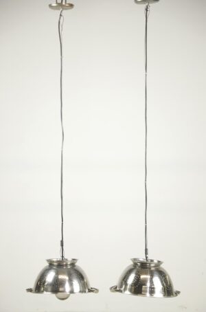 Pair of colander pendant lights with long hanging cords and perforated metal shades shown side by side.