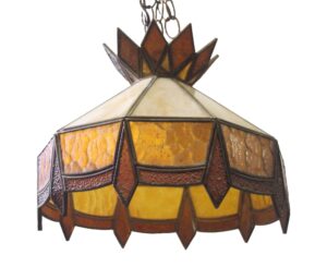 Tiffany-style pendant light with amber, orange, and burgundy stained glass panels and a crown-like top.