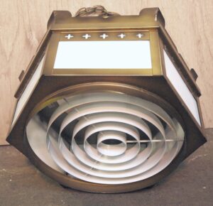 Hexagonal pendant light with white glass panels and a cross detail on the top section, shown from below.
