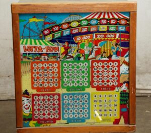 Vintage pinball machine with colorful game artwork, numbered score panels, and a wooden frame.