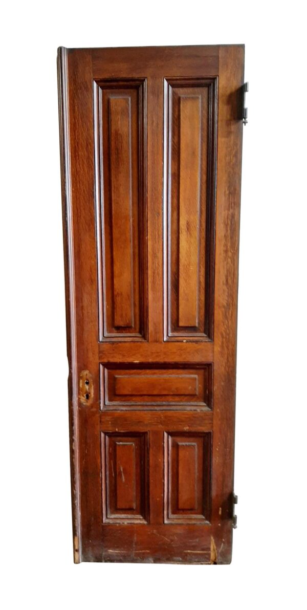 Half of an antique five-panel entry door in dark wood tone tiger oak, shown front-on with visible wood damage near the lower edge.