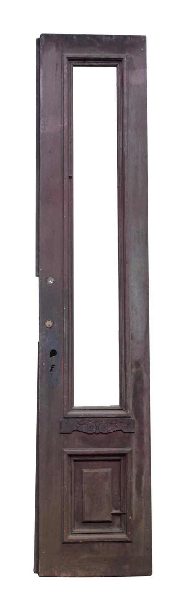 Narrow antique entry door with one long vertical panel missing glass and a square lower panel, shown in a dark wood tone.