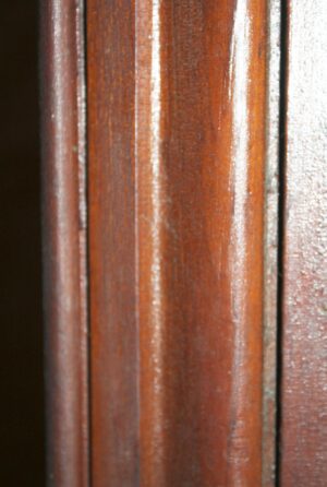 Close-up of a white entry door showing a vertical frame section and one edge of the glass opening.