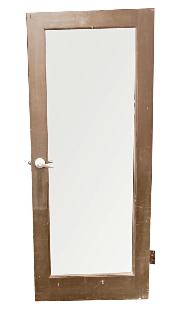 Gray wooden entry door with one large vertical glass lite and modern handle hardware.