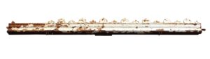 Salvaged white cast iron cornice with worn paint and several missing cast details, shown in a long horizontal view.